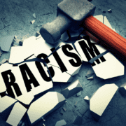 A hammer breaking what holds racism together.