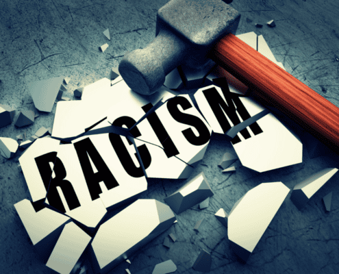 A hammer breaking what holds racism together.