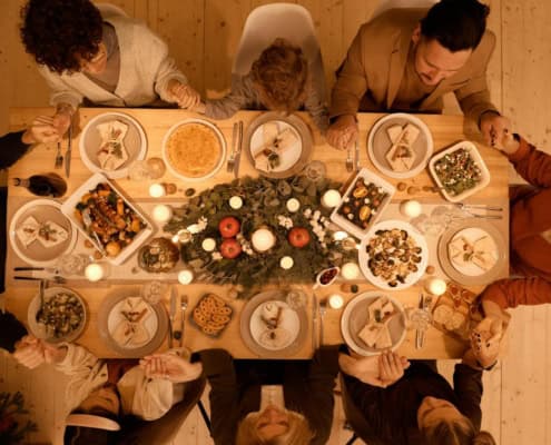 Family gathered around a beautifully set table for a festive Christmas dinner celebration.