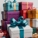 Gift boxes of all colors and sizes stacked up on top of each other with bows; calling to reflect on the spiritual impact of gift-giving in excess.