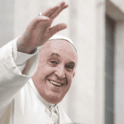 Prayer for Pope Francis accompanied by an image of a man waving, symbolizing support and unity.