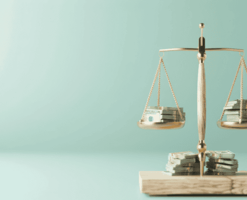 Scales holding coins showing equal stacks of money and coins. Used with resource for Economic Justice