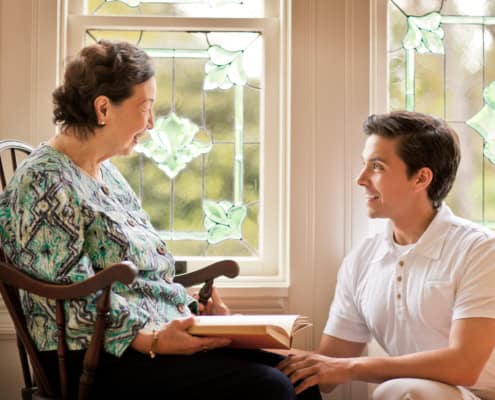 Young man offering assistance to an older woman